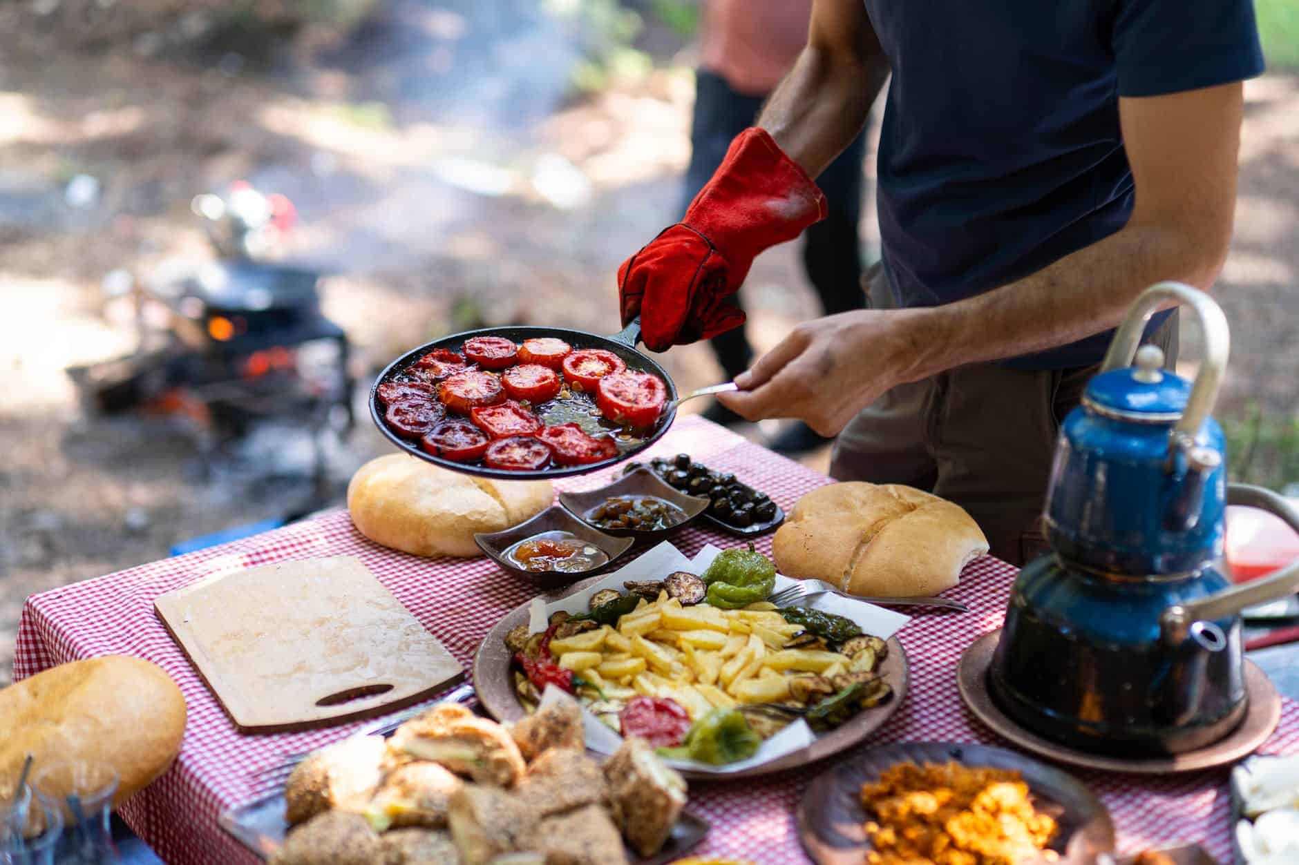 man preparing food while camping