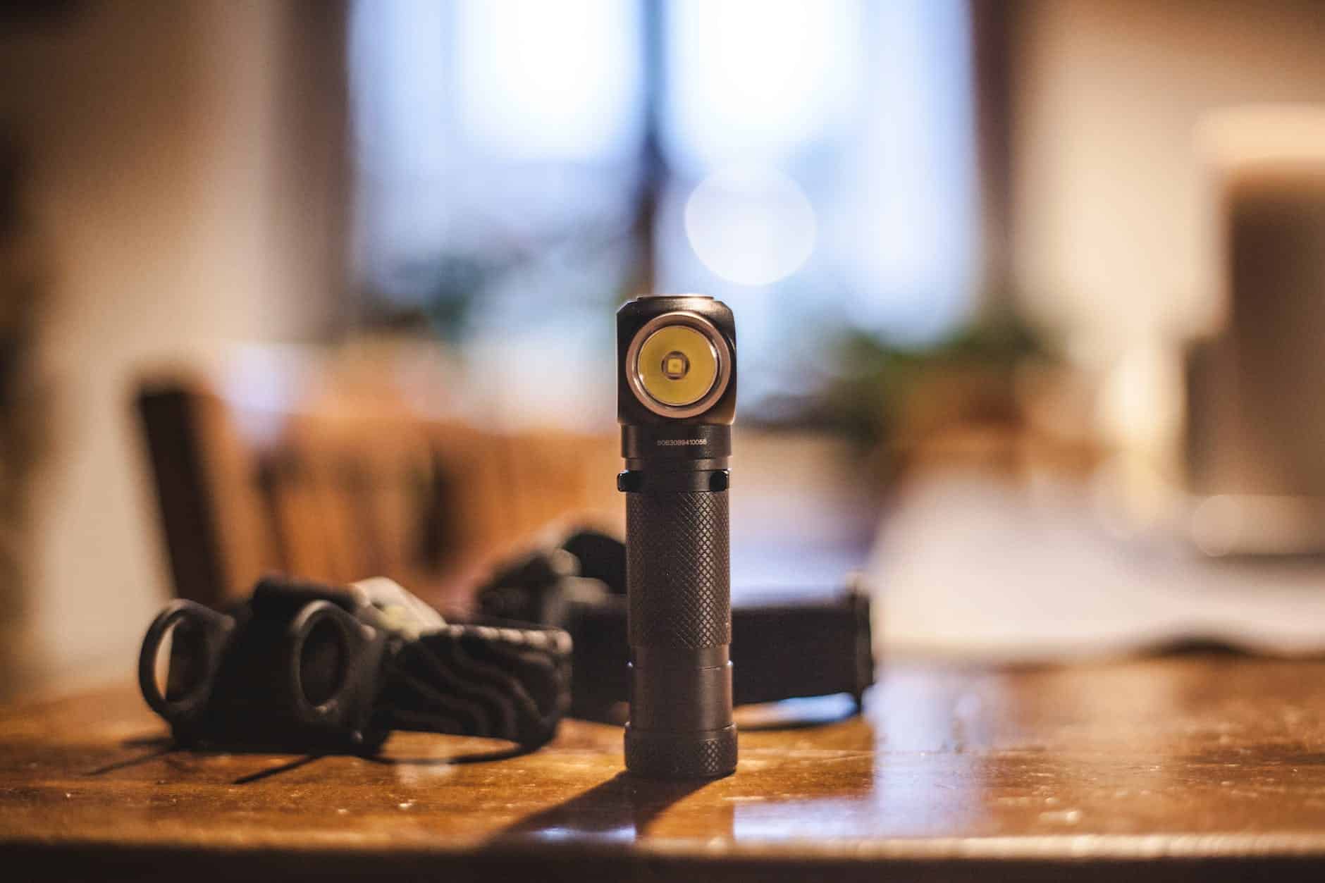 flashlight with headlamp in background.