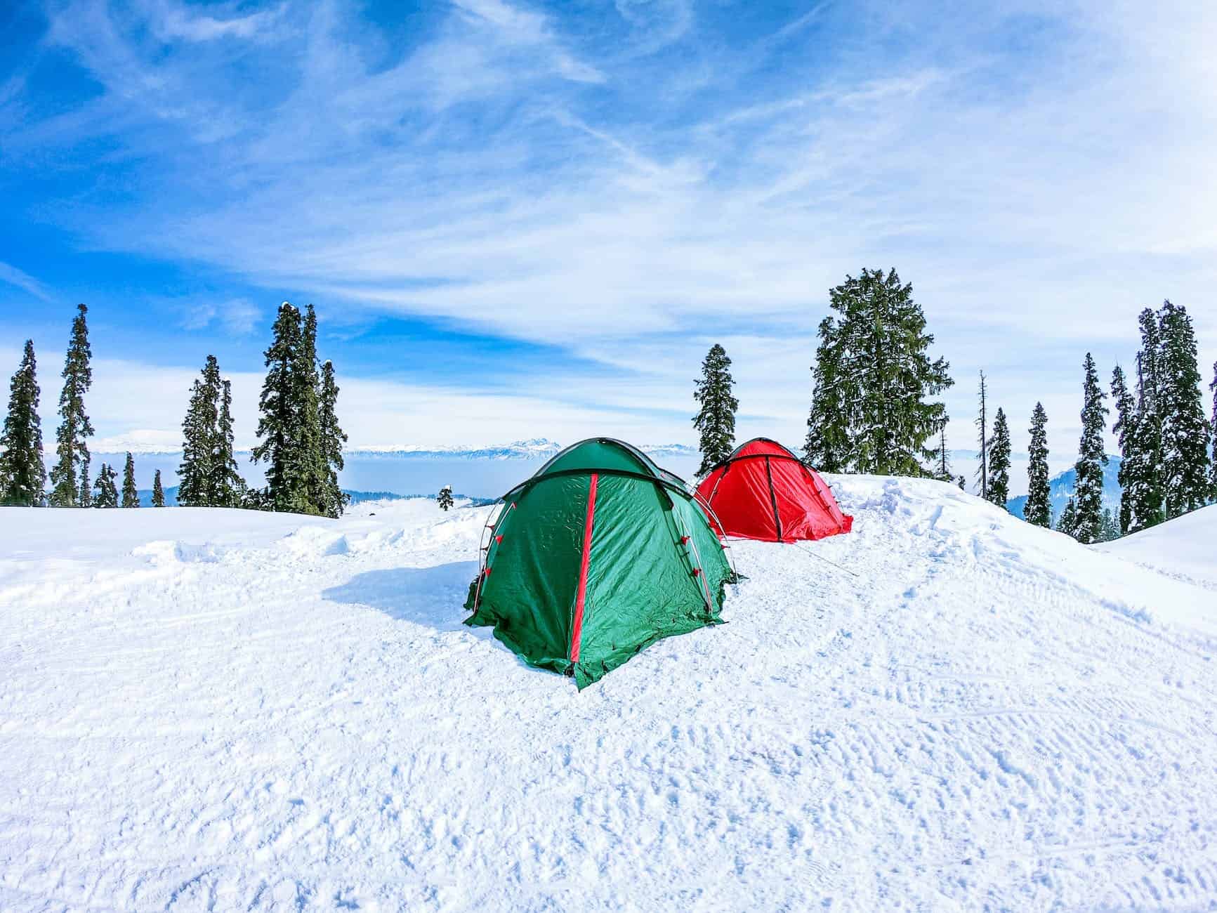green tent on snow covered ground. winter camping tent